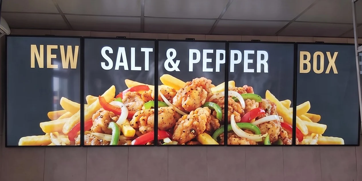 The same five screens running one promo across the wall for a new salt and pepper box